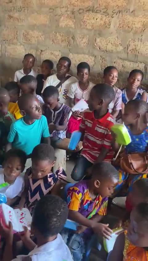 Children seated in a classroom with their gifts