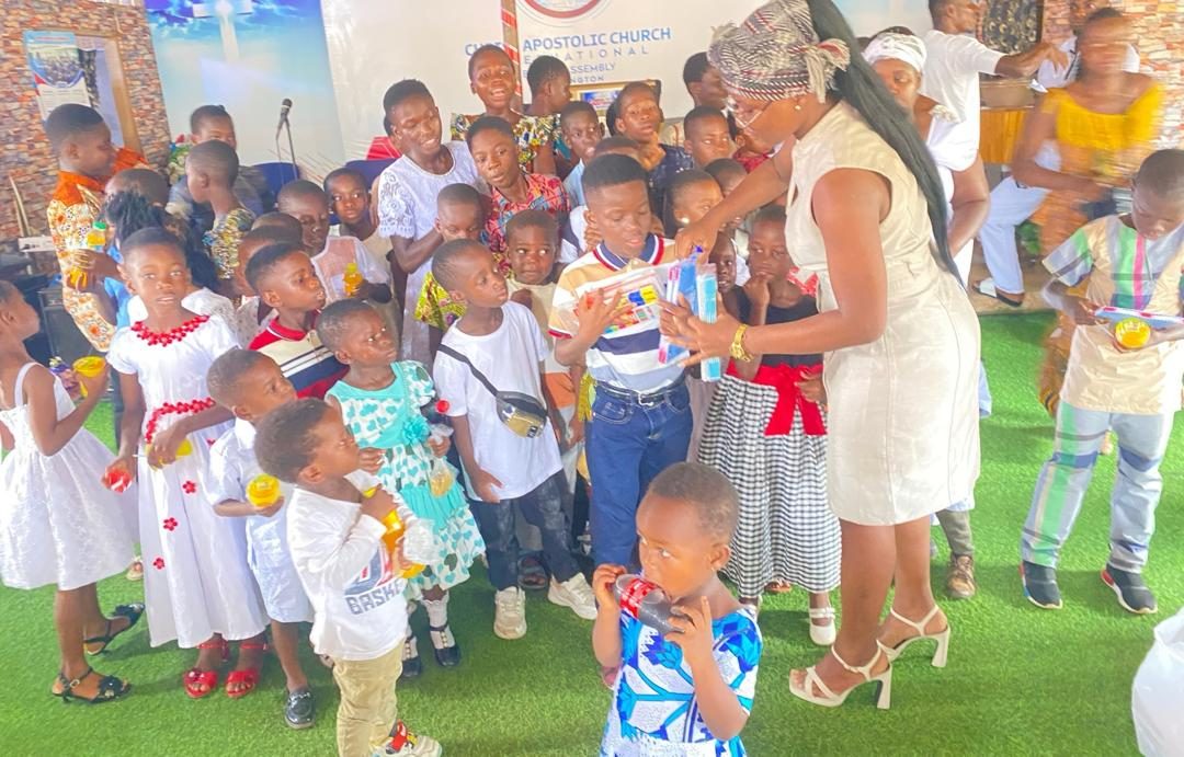 A Sunshine Project team member handing gifts to children