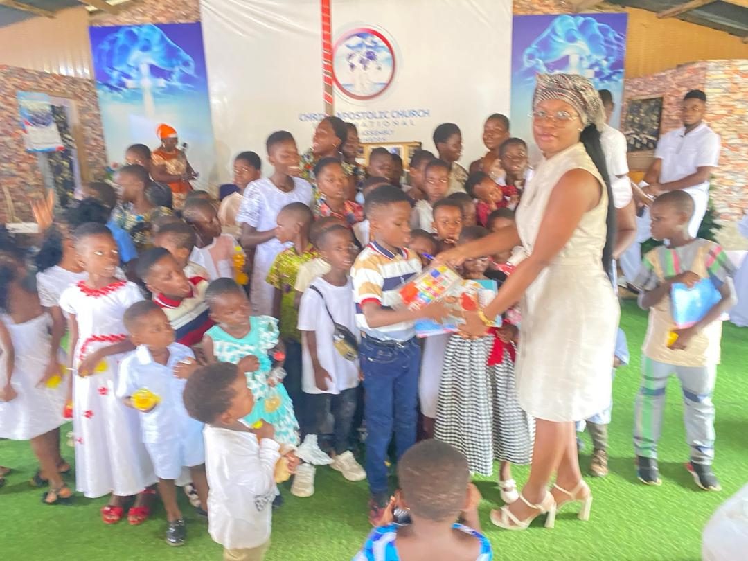 A team member handing learning materials to a child