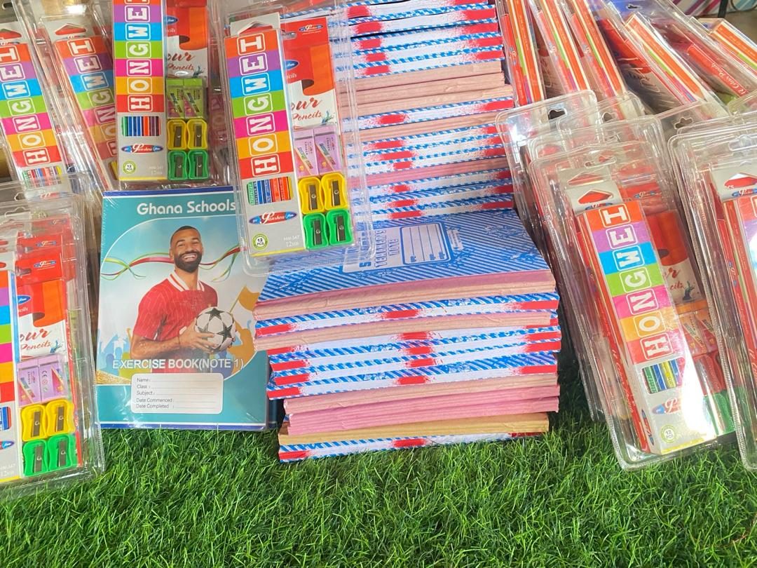 Exercise books, coloured pencils and sharpeners ready for distribution
